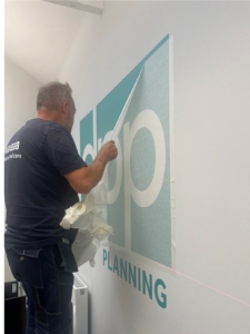 Office Essentials installation of vinyl wall mounted logo for DPP Planning